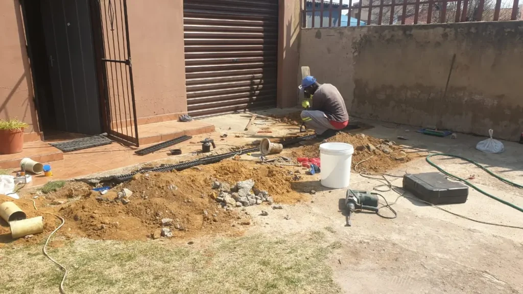 Plumbing Installation showing underground pipe installation and trench work at a residential property